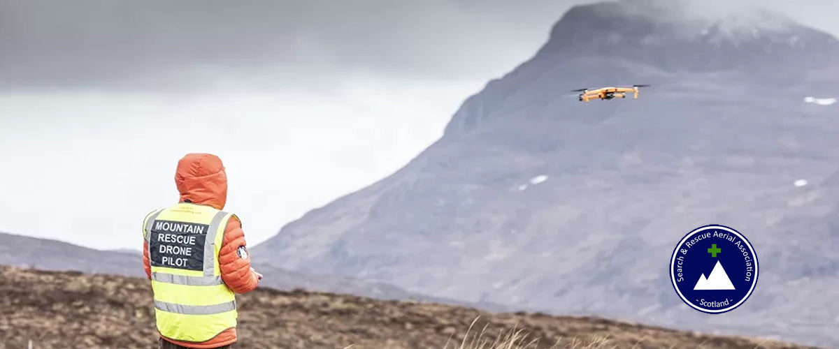 A search and rescue drone in flight over hill terrain