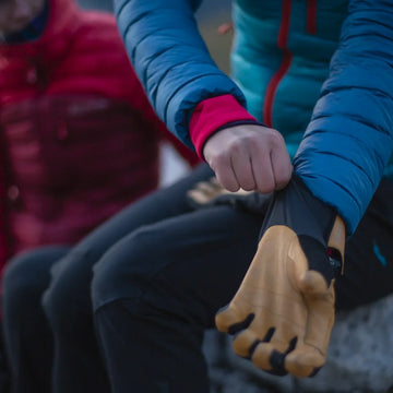 Hillwalker pulls on insulated gloves
