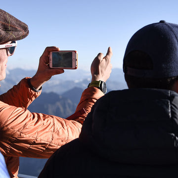 Popping on a down jacket during a break hillwalking