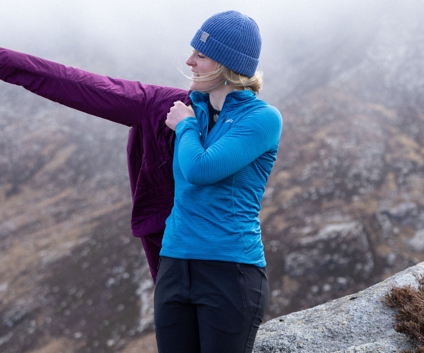 Hikers pulls on a waterproof with rain approaching