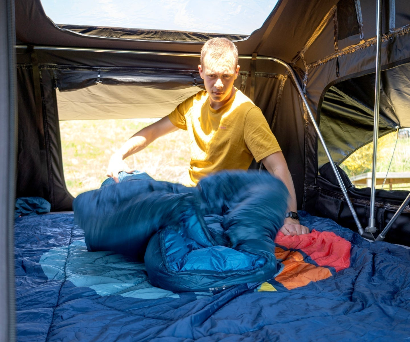 Camper preparing his sleeping bag
